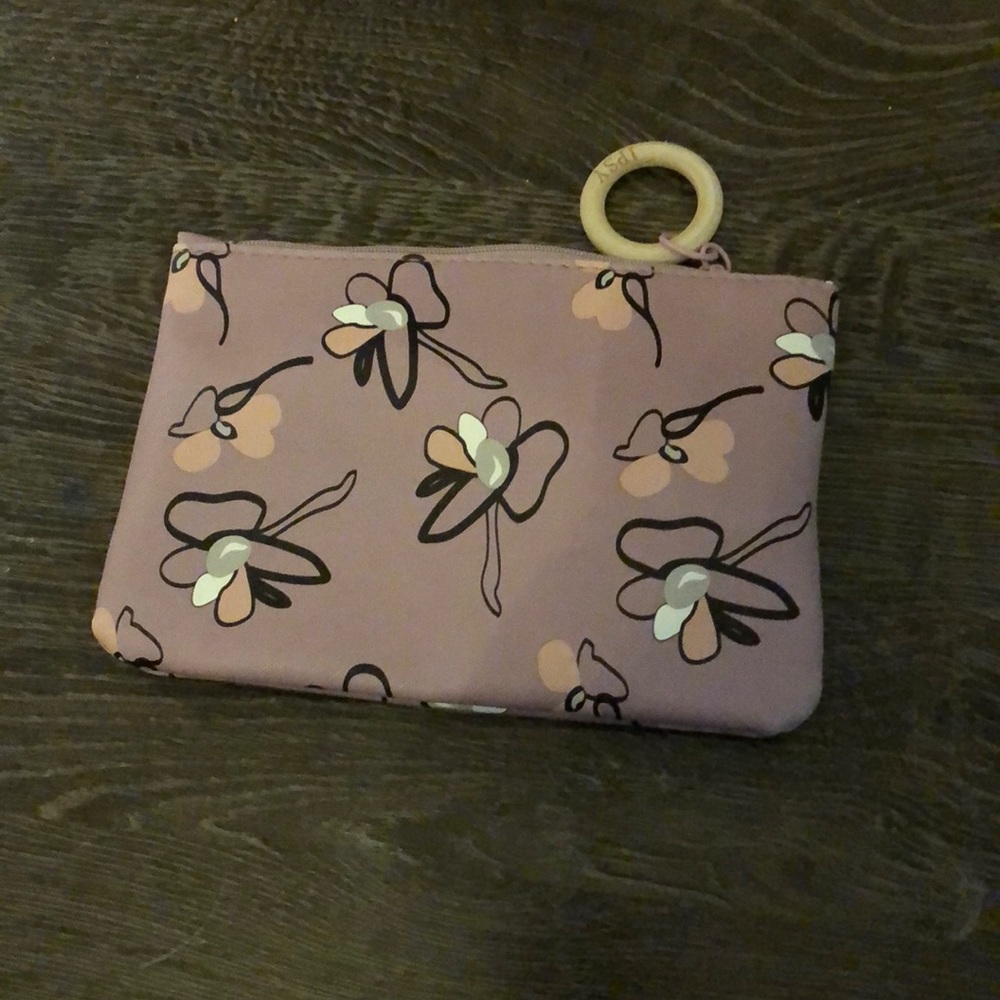 A purple hang bag with flowers on it 🌸 🌺
